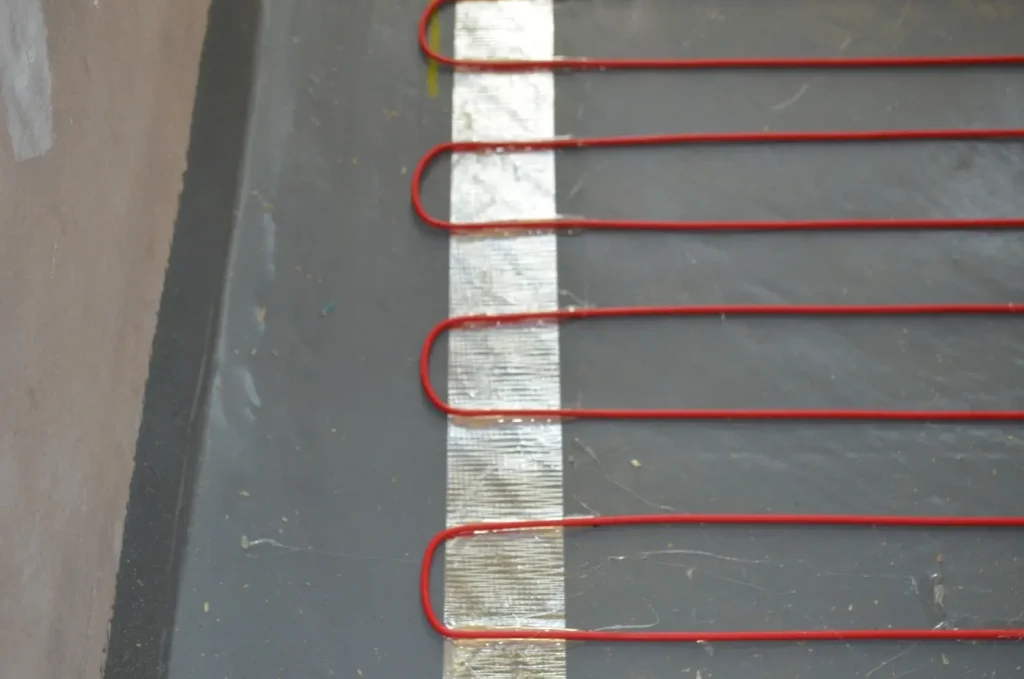 In Screed cable stuck to the waterproofed bathroom using ducting tape